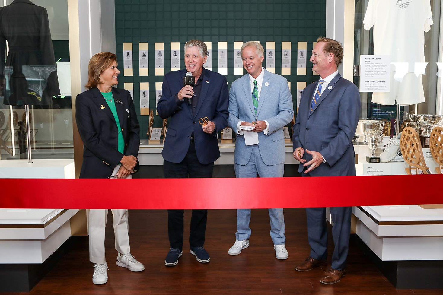 ITHF inductee Gigi Fernandez (left), Rhode Island governor Dan McKee, ITHF President Patrick McEnroe and ITHF CEO Dan Faber (right) cut the ribbon on $3 million in renovations to its museum